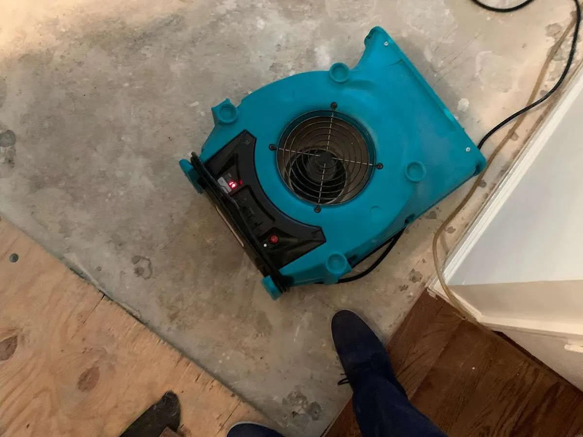 Air mover drying subfloor during Leak Detection & Repair in Adrian